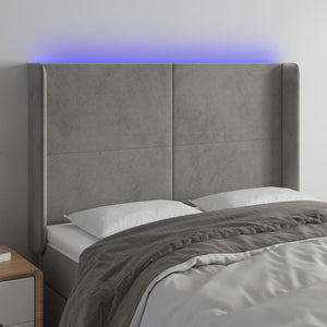 Sänggavel LED ljusgrå 147x16x118/128 cm sammet